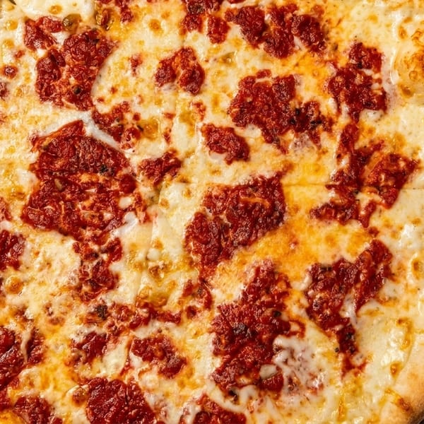 A freshly baked cheese pizza with a rich red sauce, served on a metal pan.